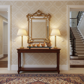 Hand-carved wooden duck family sculpture with intricate jali work displayed on polished wooden base