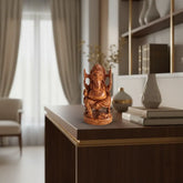 A detailed hand-carved wooden statue of Lord Ganesha, seated on a throne with intricate carvings, and his mouse vehicle at his feet.