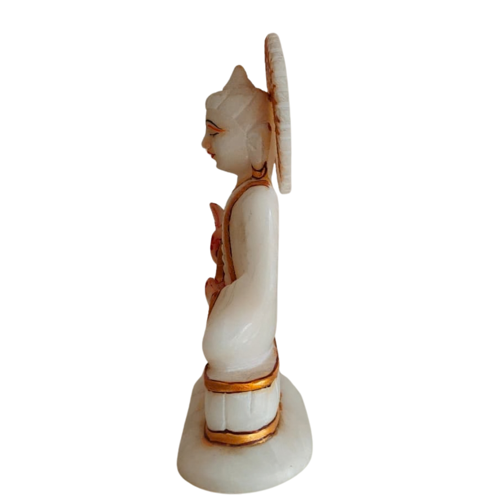 Decorative marble Buddha idol with intricate gold embellishments.