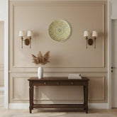 Round decorative item with intricate gold pattern on a white background