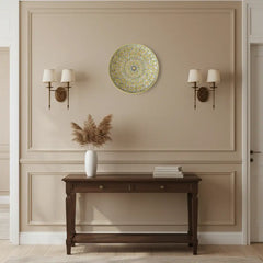 Round decorative item with intricate gold pattern on a white background