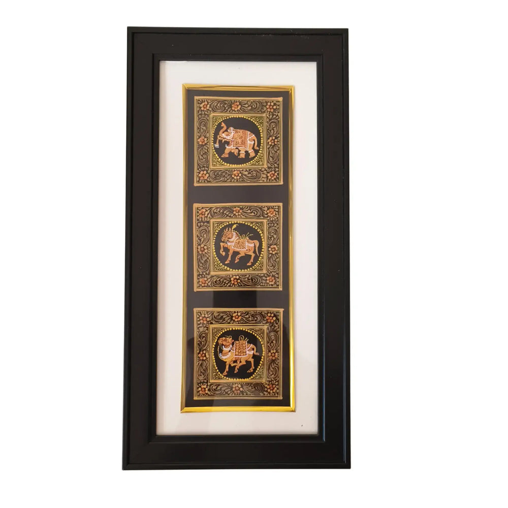 Framed artwork with three decorative panels featuring elephants on a white background