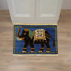 Decorative rug with an elephant design on a wooden floor.