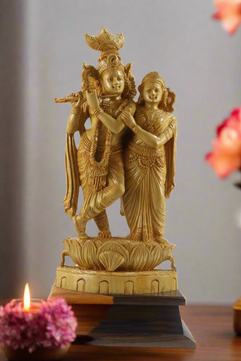 Statue of a couple on a lotus pedestal with a blurred background