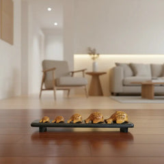 Graduated set of five hand-carved wooden fish figures displayed on wooden stand with natural finish