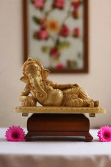 Decorative statue of a sitting figure on a wooden surface with 'Krafteria' branding.