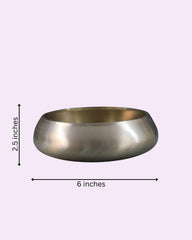 Metallic bowl with dimensions labeled on a light purple background