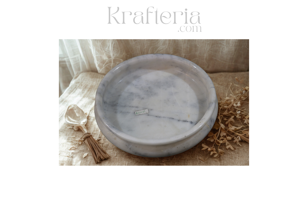 Marble-patterned bowl on a textured surface with 'Krafteria' branding.