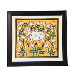 Pichwai Framed artwork of a cow among flowers on a yellow background
