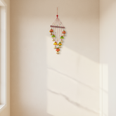 Vibrant hand-painted clay and metal bell wind chime wall hanging with colorful traditional Indian folk art design