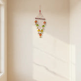 Vibrant hand-painted clay and metal bell wind chime wall hanging with colorful traditional Indian folk art design