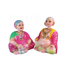 Paper macche Thalayatti Bommai Colorful figurines of elderly people on a white background