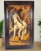 Wooden carving of a horse in a natural setting with trees and foliage.