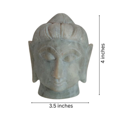 Peaceful Buddha head sculpture carved from natural marble.