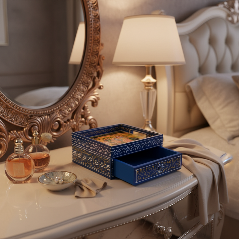 Royal blue wooden drawer box with a hand-painted lid showing a royal procession on an elephant, and intricate white and yellow patterns. The single drawer is pulled open.