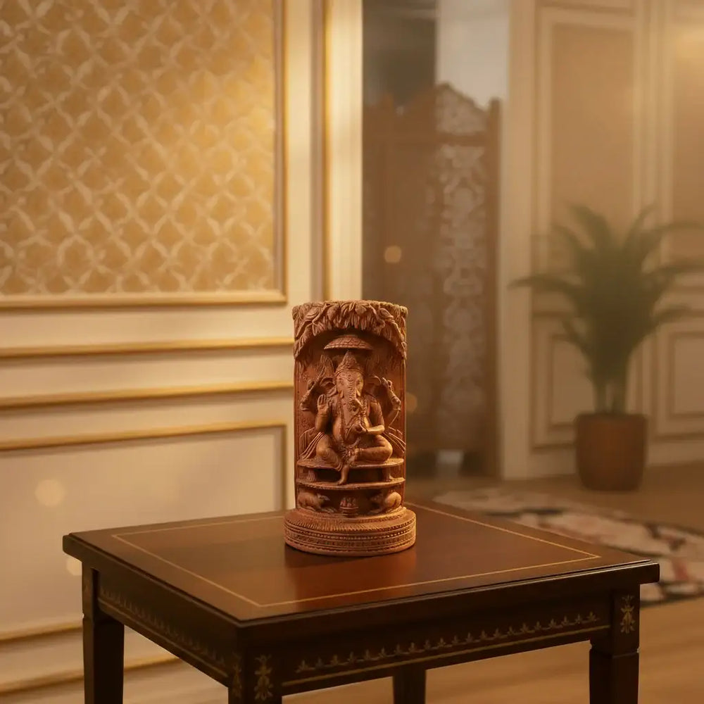 Intricately hand-carved cylindrical wooden sculpture depicting Lord Ganesha and sacred cow scenes with fine detailing