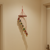 Hand-painted Indian folk art bell cascade wall hanging with colorful bells and traditional decorative design