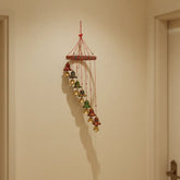 Hand-painted Indian folk art bell cascade wall hanging with colorful bells and traditional decorative design