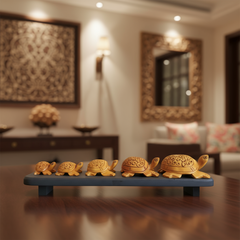 Hand-carved wooden turtle family sculpture displayed on wooden base symbolizing harmony and longevity