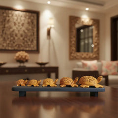 Hand-carved wooden turtle family sculpture displayed on wooden base symbolizing harmony and longevity