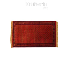 Red patterned rug with tassels on a white background, branded 'Krafteria'.