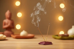 Handcrafted red soapstone incense stick holder with carved detailing.