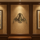 A detailed brass wall hanging depicting the face of Lord Venkateswara, adorned with a tall crown, traditional markings, and flanked by symbolic conch and discus motifs.