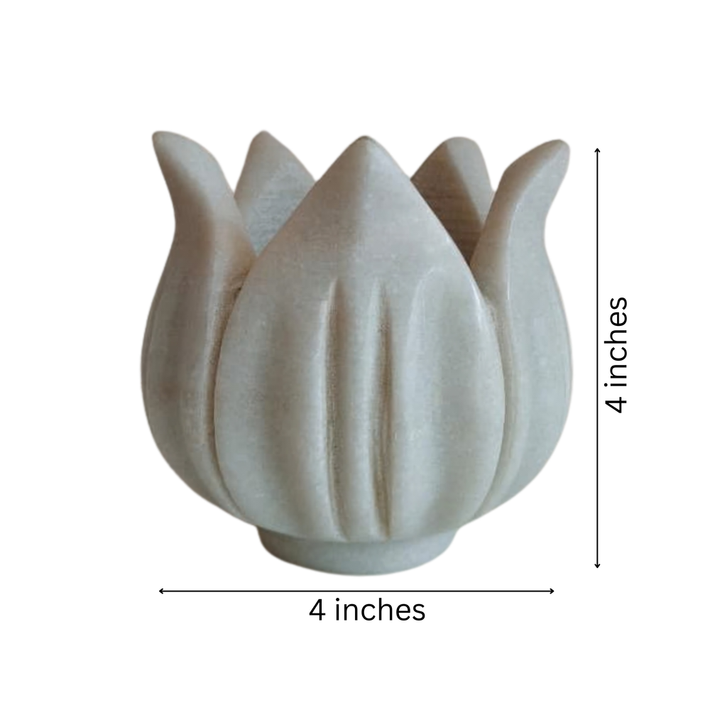 Decorative white marble lotus diya stand for spiritual spaces.