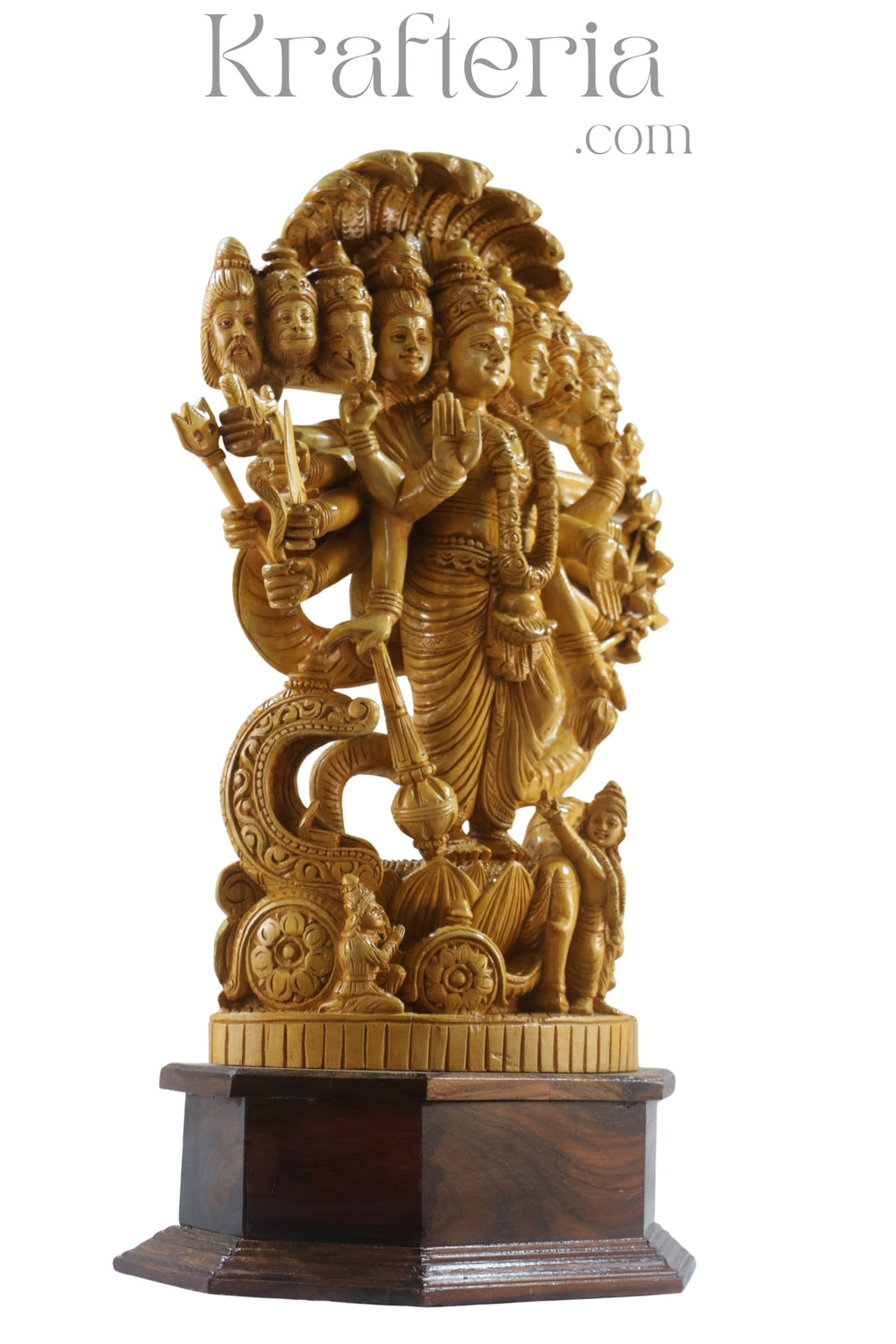 Gold-colored statue with multiple faces and a chariot on a wooden base, branded 'Krafteria'.