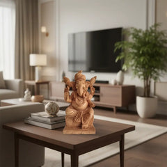 Hand-carved wooden statue of Lord Ganesha, seated with intricate details and traditional attire, against a light background.