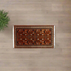 Decorative rug with intricate patterns on a wooden floor