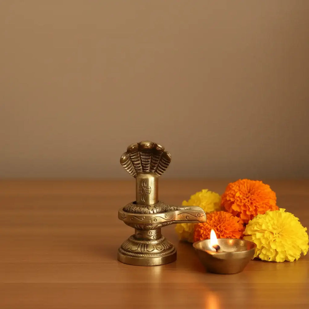 Sacred Brass Shiva Lingam and Yoni Pitha Adorned with Multi-Hooded Naga Brass Ware