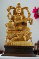 Gold-colored statue of a deity playing a stringed instrument on a wooden base, with 'Kraftopia' branding.