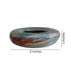 Solid onyx ashtray with deep center and cigarette rests.