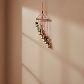 Hand-painted elephant and golden bell wind chime wall hanging with colorful folk art design for home décor