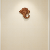 Hand-carved wooden Ganesha elephant head wall hanging with intricate detailing for home temple décor