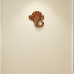Hand-carved wooden Ganesha elephant head wall hanging with intricate detailing for home temple décor