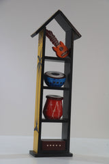 Decorative shelf with musical instrument models on a plain background