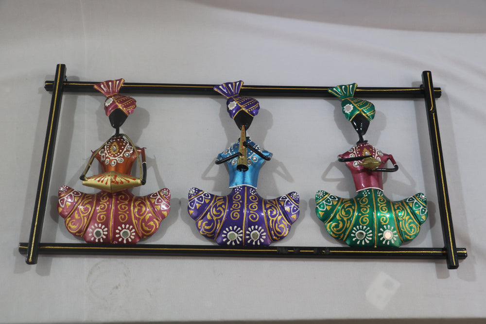 Decorative wall art with three colorful figurines on a white background