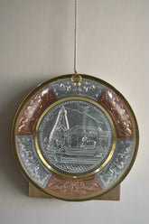 Decorative plate with intricate designs on a plain background