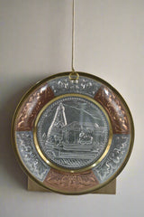 Decorative plate with intricate designs on a plain background