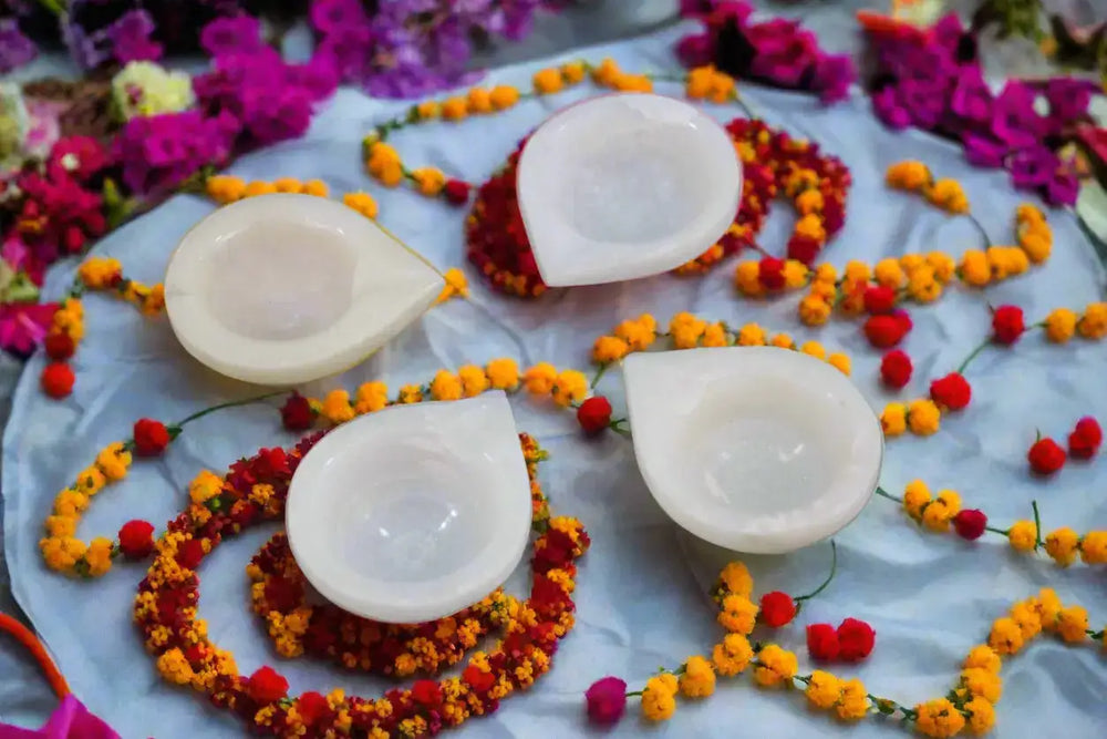 Four teardrop-shaped white stones on a gray background