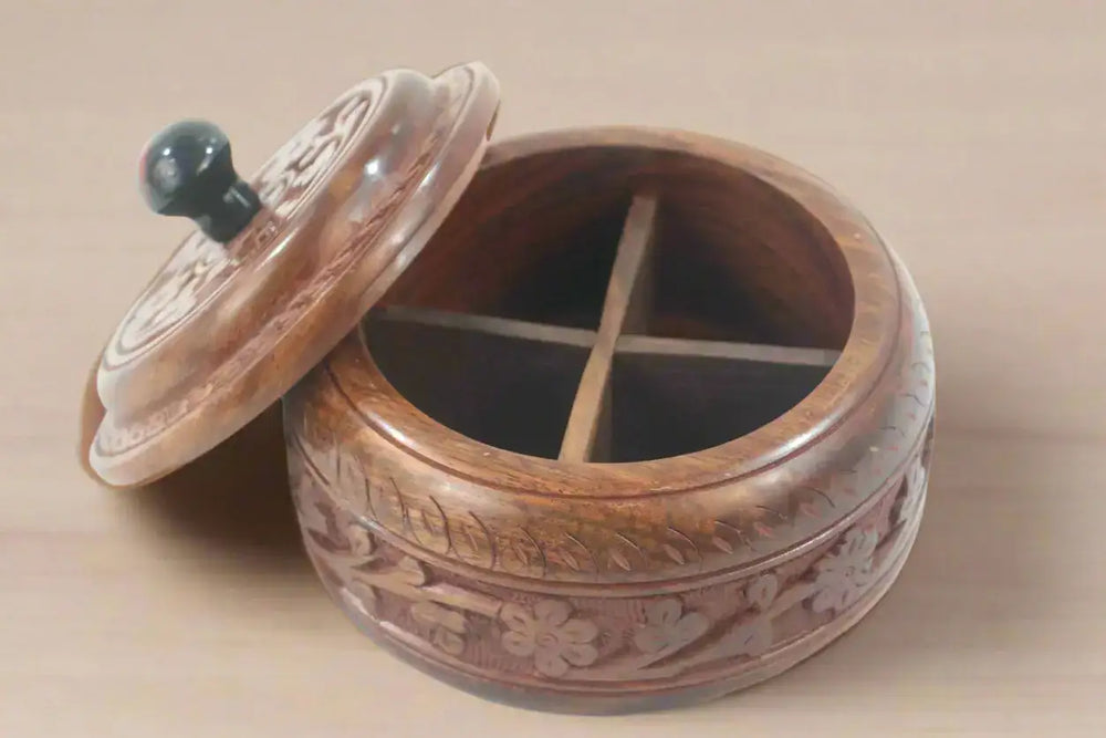 Wooden container with lid and carved design on a white background