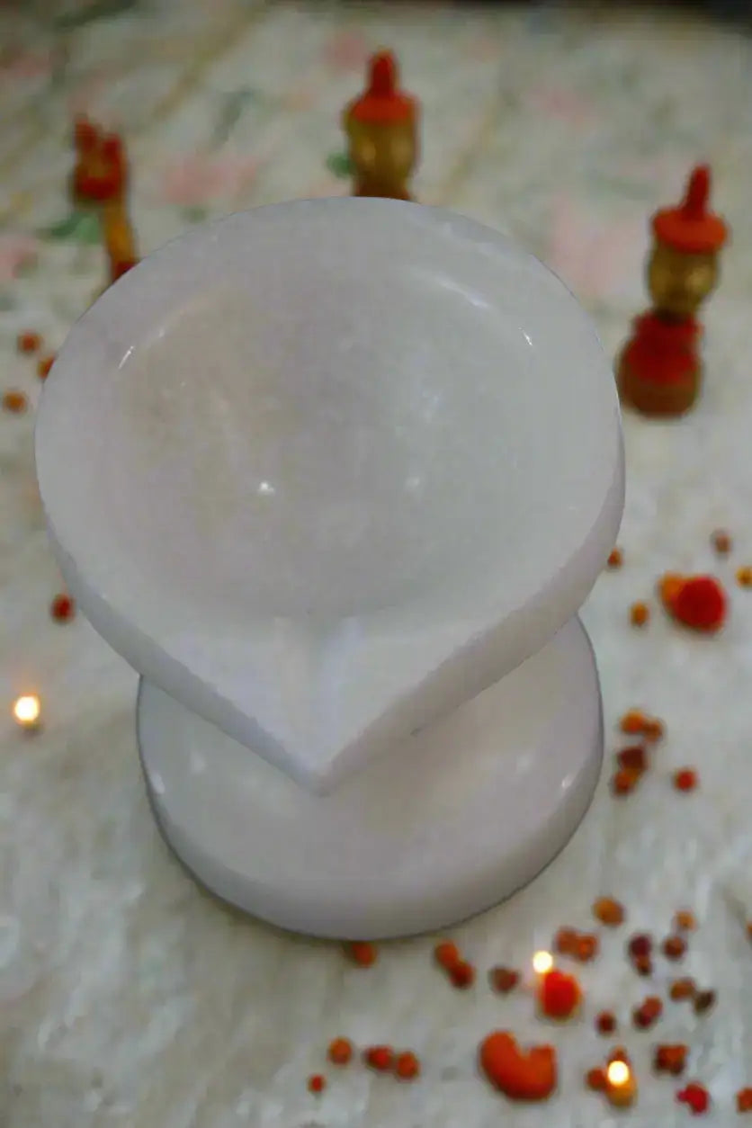 Two white silicone cups on a black background