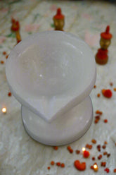 Two white silicone cups on a black background