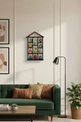 Decorative shelf with colorful vases against a pink background