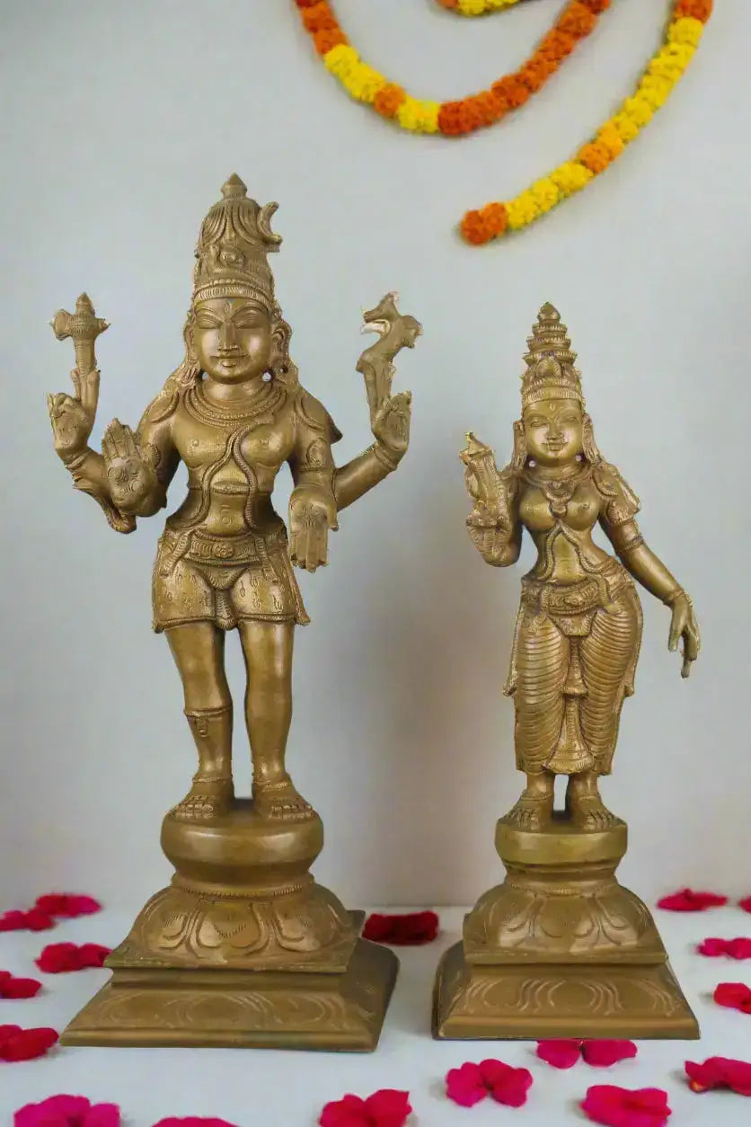Two gold-colored statues on a gray background