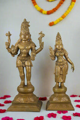 Two gold-colored statues on a gray background