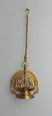 Decorative gold hanging object on a gray background