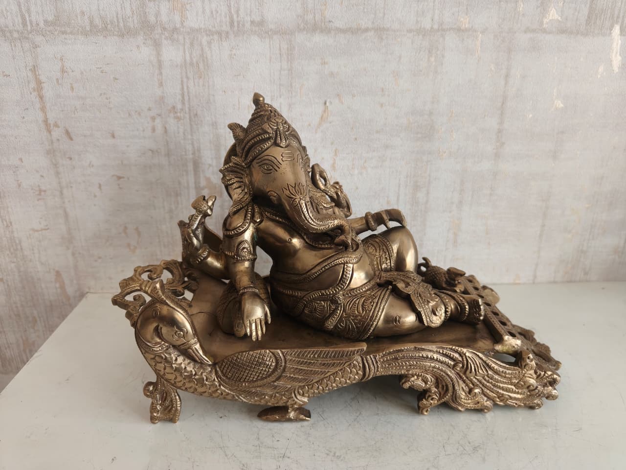 Brass Reclining Ganesha Statue – Traditional Relaxed Ganesha on Peacock Couch Idol Brass Artwork